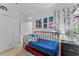 bedroom with metal bed frame, wall decorations, and a dark dresser beside the bed at 2676 Spider Lily Ct, Clermont, FL 34711