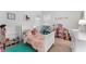 Bright bedroom with a large window, a bed covered in toys, and walls decorated with colorful art at 2676 Spider Lily Ct, Clermont, FL 34711