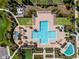 Aerial view of community pool with surrounding lounge chairs and landscaping at 2676 Spider Lily Ct, Clermont, FL 34711