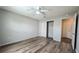Bedroom featuring hardwood floors, closet, ceiling fan, and neutral paint at 3449 Roanoke St, The Villages, FL 32162