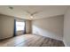 Bright bedroom showcasing hardwood floors, a ceiling fan, and neutral paint at 3449 Roanoke St, The Villages, FL 32162