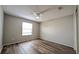 Cozy bedroom showcasing hardwood floors, a ceiling fan, and natural light at 3449 Roanoke St, The Villages, FL 32162