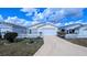Charming single-story home with a well-maintained front yard, white picket fence, and driveway at 3449 Roanoke St, The Villages, FL 32162