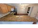Kitchen view showing countertop bar, white appliances, and a laundry closet at 3449 Roanoke St, The Villages, FL 32162