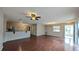 Open-concept living area with wood flooring, natural light, and a breakfast bar adjacent to the kitchen at 3449 Roanoke St, The Villages, FL 32162