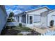 The home features a cozy screened lanai, white picket fence, and a meticulously maintained landscape at 3449 Roanoke St, The Villages, FL 32162