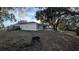 Backyard view of house with large trees at 3639 Bream Cir, Fruitland Park, FL 34731