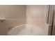 Bright bathroom featuring a large soaking tub with tile surround and glass shower doors at 3639 Bream Cir, Fruitland Park, FL 34731