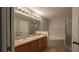 A bright bathroom features a dual sink vanity, soaking tub, and glass enclosed shower at 3639 Bream Cir, Fruitland Park, FL 34731