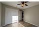 Bedroom features wood-look flooring, closet, and neutral paint at 3639 Bream Cir, Fruitland Park, FL 34731