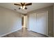 Bedroom features wood-look flooring, closet, and neutral paint at 3639 Bream Cir, Fruitland Park, FL 34731