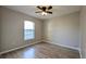 Empty bedroom featuring hard surface floors, ceiling fan, and natural light at 3639 Bream Cir, Fruitland Park, FL 34731