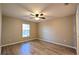 A bedroom with wood floors and beige colored walls featuring a single window at 3639 Bream Cir, Fruitland Park, FL 34731