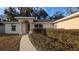 House entrance with columns and landscaped walkway at 3639 Bream Cir, Fruitland Park, FL 34731