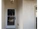 Front door entrance with glass panel and light fixture at 3639 Bream Cir, Fruitland Park, FL 34731