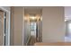 A hallway with light colored walls and light vinyl flooring is well lit at 3639 Bream Cir, Fruitland Park, FL 34731