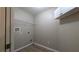 A utility room features a wire rack shelf with gray colored walls and floors at 3639 Bream Cir, Fruitland Park, FL 34731