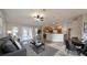 Spacious living room open to a modern kitchen, featuring hardwood floors and a cozy seating area at 3639 Bream Cir, Fruitland Park, FL 34731