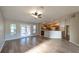 Open living room with wood-look floors and kitchen access at 3639 Bream Cir, Fruitland Park, FL 34731