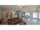 Open-concept living room with wood floors, ceiling fan, and easy access to the kitchen and dining area at 3639 Bream Cir, Fruitland Park, FL 34731