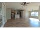 Bright and airy living room with wood floors and a modern ceiling fan and easy access to the kitchen at 3639 Bream Cir, Fruitland Park, FL 34731