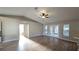 Bright, open living room with wood floors, neutral walls, and a view of the backyard through double doors at 3639 Bream Cir, Fruitland Park, FL 34731