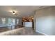 Sunlit living room with hardwood floors, ceiling fan, and seamless kitchen access at 3639 Bream Cir, Fruitland Park, FL 34731