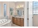 Bathroom with double vanity and a large mirror at 38626 Lakeview Walk, Lady Lake, FL 32159