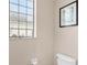 Small bathroom with toilet and a decorative glass block window at 38626 Lakeview Walk, Lady Lake, FL 32159
