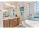 Bathroom with double vanity and a large mirror at 38626 Lakeview Walk, Lady Lake, FL 32159