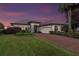 Elegant one-story home with brick driveway and landscaping at 38626 Lakeview Walk, Lady Lake, FL 32159