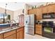 Kitchen with stainless steel appliances and granite counters at 38626 Lakeview Walk, Lady Lake, FL 32159
