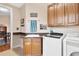 Spacious laundry room with wooden cabinets and a sink at 38626 Lakeview Walk, Lady Lake, FL 32159