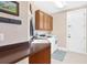 Laundry room with washer, dryer, cabinets, and utility sink at 38626 Lakeview Walk, Lady Lake, FL 32159