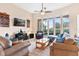 Bright living room featuring a large TV and comfortable seating at 38626 Lakeview Walk, Lady Lake, FL 32159