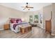 Bright bedroom with king-size bed and wood flooring at 38626 Lakeview Walk, Lady Lake, FL 32159