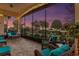 Relaxing screened porch with comfortable seating and string lights at 38626 Lakeview Walk, Lady Lake, FL 32159