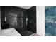 Modern bathroom with dark tile walls, a sleek vanity, and contemporary fixtures at 39817 Forest Dr, Eustis, FL 32736