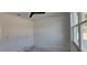 White bedroom featuring a window overlooking the outside, allowing for natural light at 39817 Forest Dr, Eustis, FL 32736