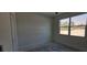 White bedroom featuring a window overlooking the outside, allowing for natural light at 39817 Forest Dr, Eustis, FL 32736