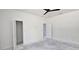 Bright bedroom with open closet and doorway, featuring a ceiling fan at 39817 Forest Dr, Eustis, FL 32736
