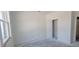 Bright, white bedroom featuring a window for natural light and an open closet at 39817 Forest Dr, Eustis, FL 32736