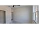 Bright, white bedroom featuring an open closet and doorway, allowing for natural light at 39817 Forest Dr, Eustis, FL 32736