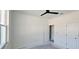 Bright bedroom with closet and doorway, featuring a ceiling fan at 39817 Forest Dr, Eustis, FL 32736