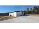 Modern home with a white exterior, black trim, a concrete driveway, and desert-style landscaping at 39817 Forest Dr, Eustis, FL 32736