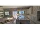 Spacious kitchen featuring white cabinets, a large island with marble countertops and stainless steel appliances at 39817 Forest Dr, Eustis, FL 32736