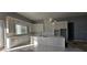 Bright, spacious kitchen featuring a large kitchen island, white cabinets, stainless steel appliances, and marble countertops at 39817 Forest Dr, Eustis, FL 32736