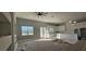 Bright, open-concept living area featuring a stylish ceiling fan, white cabinets, and views of the backyard at 39817 Forest Dr, Eustis, FL 32736
