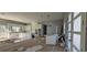 Bright, open-concept living area with white cabinets, island, and door to a tranquil backyard setting at 39817 Forest Dr, Eustis, FL 32736