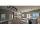 Open-concept living area with modern lighting, built-in shelving, and access to a kitchen with stainless steel appliances at 39817 Forest Dr, Eustis, FL 32736